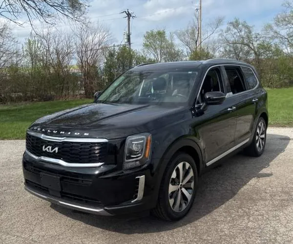 A black 2022 Kia Telluride parked in an empty street