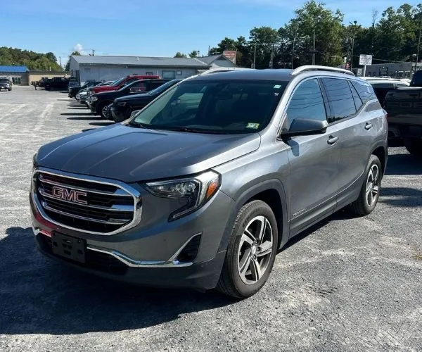 A used grey 2021 GMC Terrain in a dealer parking lot