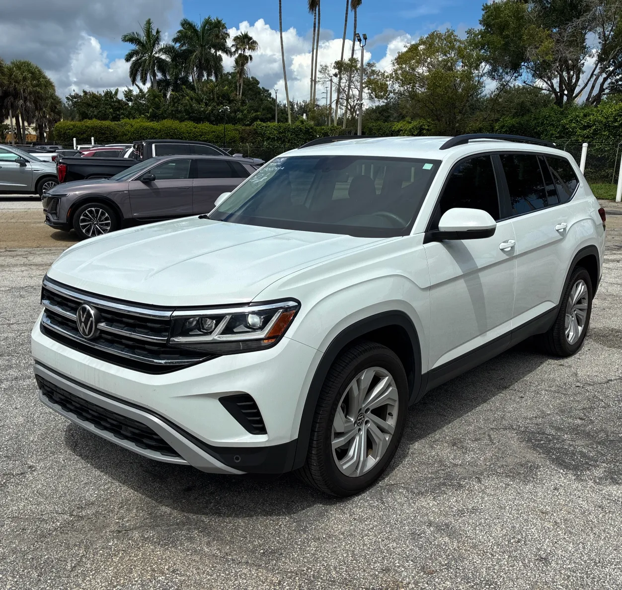 A white 2022 VW Atlas parked in a dealer lot.
