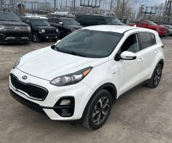 A white 2021 Kia Sportage in a full dealer lot