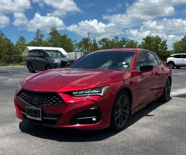 A red 2022 Acura TLX on a parking lot